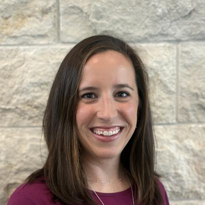 Mandy in front of the limestone wall 2025